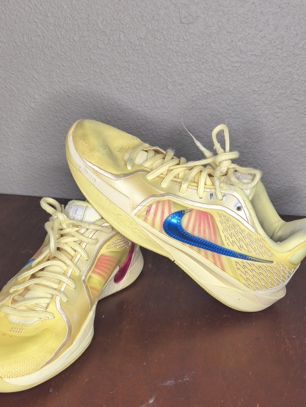 Nike Yellow Sneakers with Blue Swoosh and Pink Heel Accent